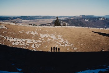 shadow of 4 people on dirt ground