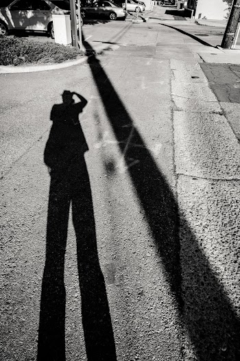 Shadow of a person on Asphalt Road
