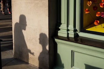 shadows of people reflecting on wall