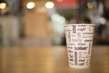 Shallow Depth of Field Photo of Disposable Cup on Brown Surface