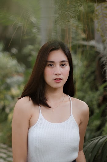 Shallow Focus Photo Of A Young Woman Wearing White Camisole