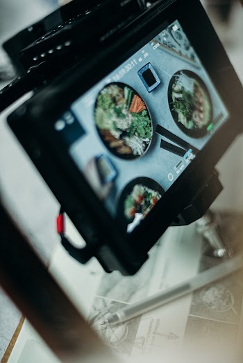 Shallow Focus Photo of Black Monitor Showing Dishes