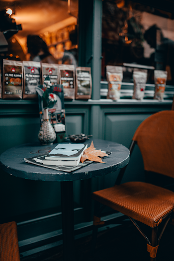 Shallow Focus Photo of Book on Round Wooden Table