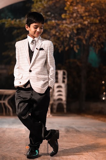 Shallow Focus Photo of Boy Wearing White Coat