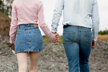 Shallow Focus Photo of Couple Holding Hands