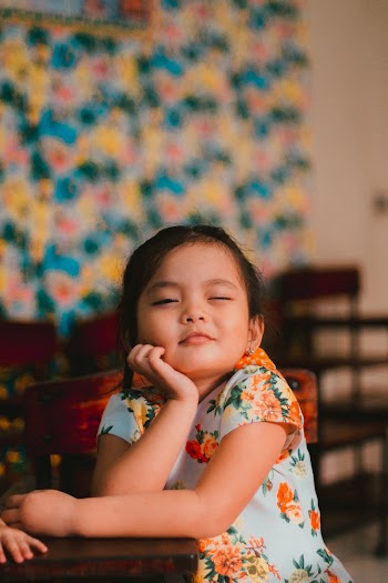 Shallow Focus Photo of Girl Winking