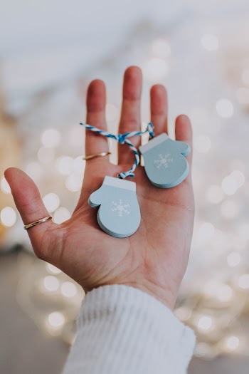 Shallow Focus Photo of Gloves Ornaments on Person's Hand