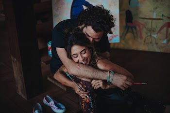Shallow Focus Photo of Man Hugging Woman