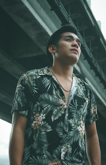 Shallow Focus Photo of Man in Black and Green Floral Button-up Top