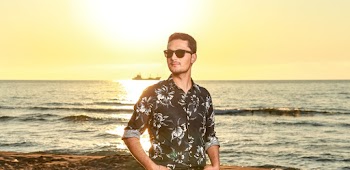 Shallow Focus Photo Of Man In Black And White Floral Dress Shirt Wearing Black Sunglasses