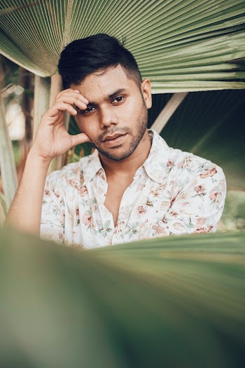 Shallow Focus Photo of Man in White and Brown Floral Button-up Shirt