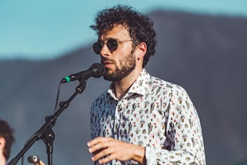 Shallow Focus Photo of Man in White Dress Shirt Singing
