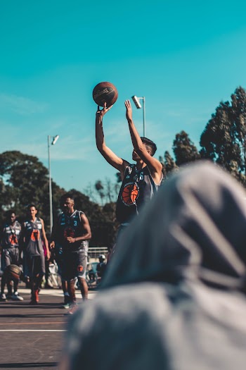 Shallow Focus Photo of Man Shooting The Ball