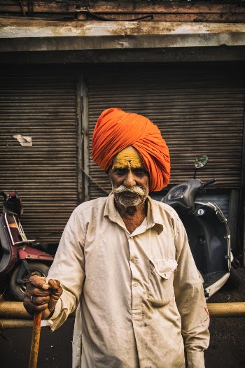 Shallow Focus Photo Of Man Wearing Orange Turban Headdress