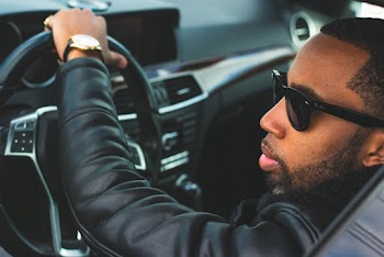 Shallow Focus Photo of Man Wearing Sunglasses Driving Car