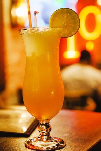 Shallow Focus Photo Of Orange Liquid On Footed Glass Cup