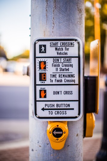 Shallow Focus Photo of Pedestrian Signage