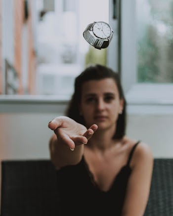 Shallow Focus Photo of Person Throwing Round Silver-colored Analog Watch With Link Bracelet