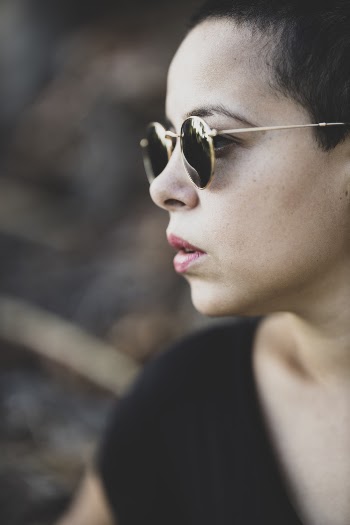 Shallow Focus Photo of Person Wearing Black Sunglasses