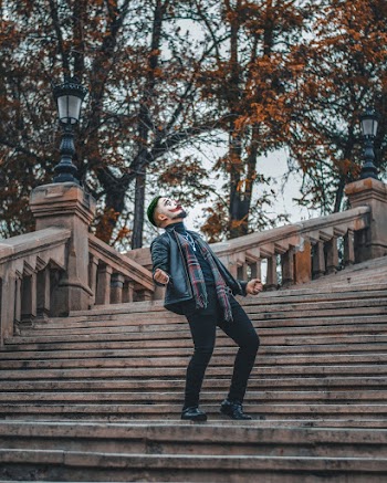 Shallow Focus Photo of Person With Face Paint Standing on Stairs