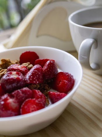 Shallow Focus Photo of Sliced Strawberries on White Ceramic Bowl