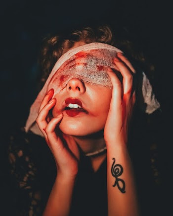 Shallow Focus Photo of Woman Covering Face With White Textile