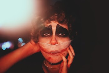 Shallow Focus Photo of Woman Covering Mouth With White Textile
