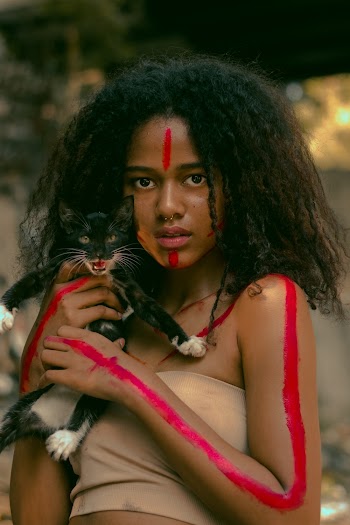 Shallow Focus Photo of Woman Holding Black Cat