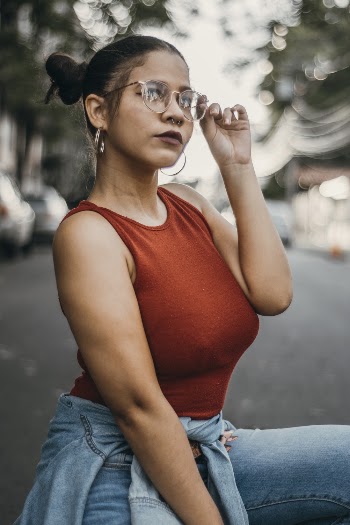 Shallow Focus Photo of Woman Holding Her Eyeglasses