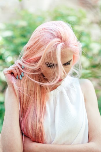 Shallow Focus Photo of Woman Holding Her Hair