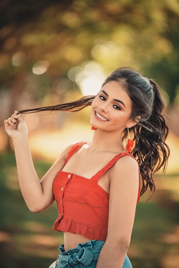Shallow Focus Photo of Woman Holding Her Hair