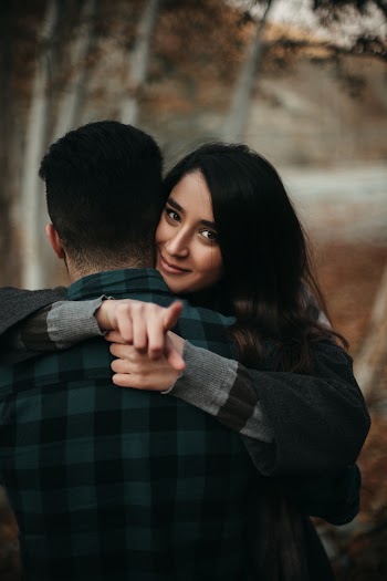 Shallow Focus Photo of Woman Hugging Man