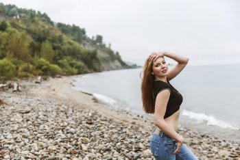 Shallow Focus Photo of Woman in Black Cap-sleeved Crop Top
