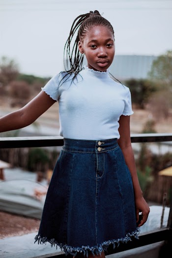 Shallow Focus Photo of Woman in Blue Denim Skirt