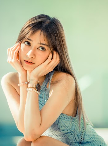 Shallow Focus Photo of Woman in Blue Sleeveless Shirt