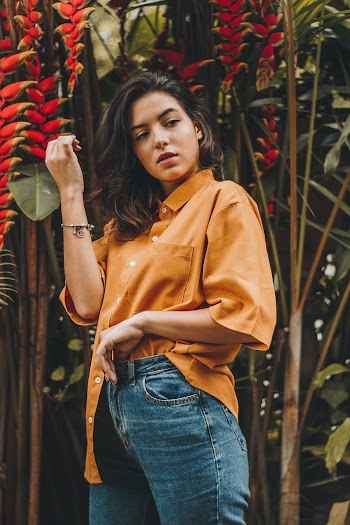 Shallow Focus Photo of Woman in Brown Button-up T-shirt