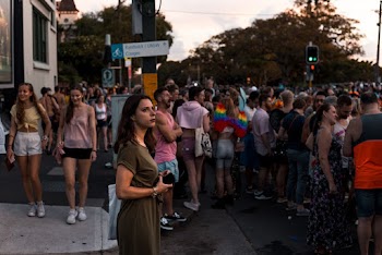 Shallow focus photo of woman in brown dress holding a smartphone