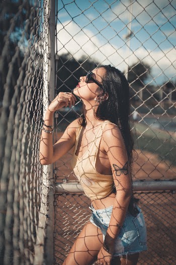 Shallow Focus Photo of Woman in Brown Sleeveless Crop Top