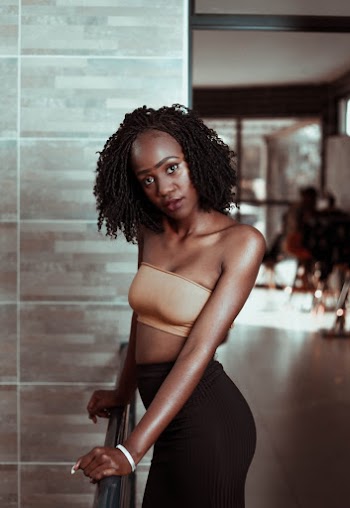 Shallow Focus Photo of Woman in Brown Strapless Crop Top