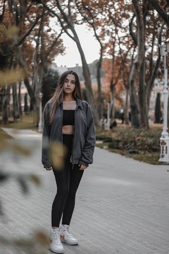Shallow Focus Photo of Woman in Gray Jacket Walking In The Park  