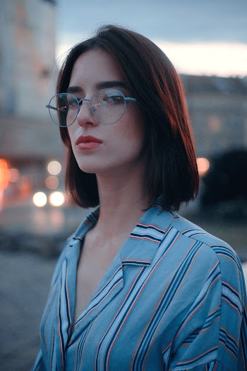 Shallow Focus Photo of Woman in Gray, White, and Brown Striped Button-up Shirt