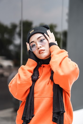 Shallow Focus Photo of Woman in Orange Hoodie