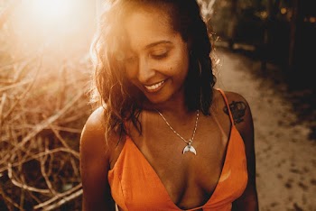 Shallow Focus Photo of Woman in Orange Spaghetti Strap Top