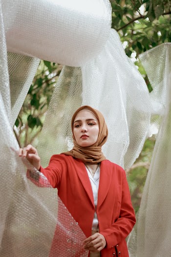 Shallow Focus Photo of Woman in Red Coat Wearing Brown Hijab