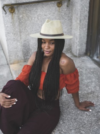 Shallow Focus Photo of Woman in Red Off-shoulder Top Wearing Fedora Hat