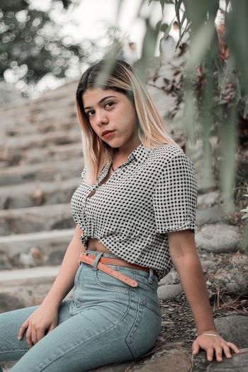 Shallow Focus Photo of Woman in White and Black Crop Top T-shirt