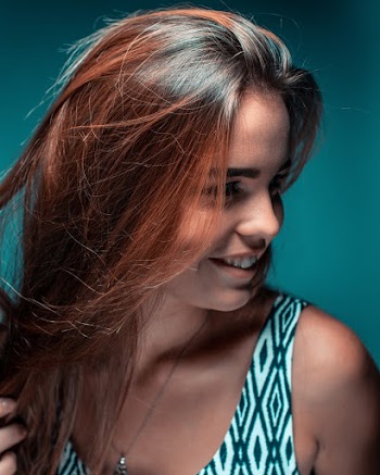 Shallow Focus Photo of Woman in White and Black Sleeveless Top