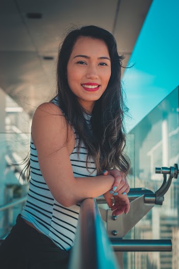 Shallow Focus Photo Of Woman In White And Black Striped Sleeveless Shirt