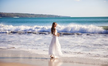 Shallow Focus Photo of Woman in White Dress By The Beach