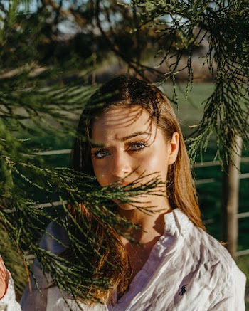 Shallow Focus Photo of Woman in White Polo by Ralph Lauren Long-sleeved Shirt Near Leaves